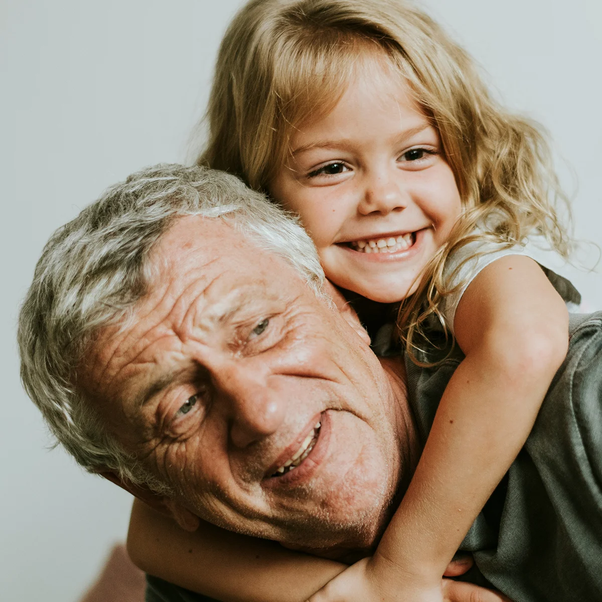 Grandfather and grandchild smiling together